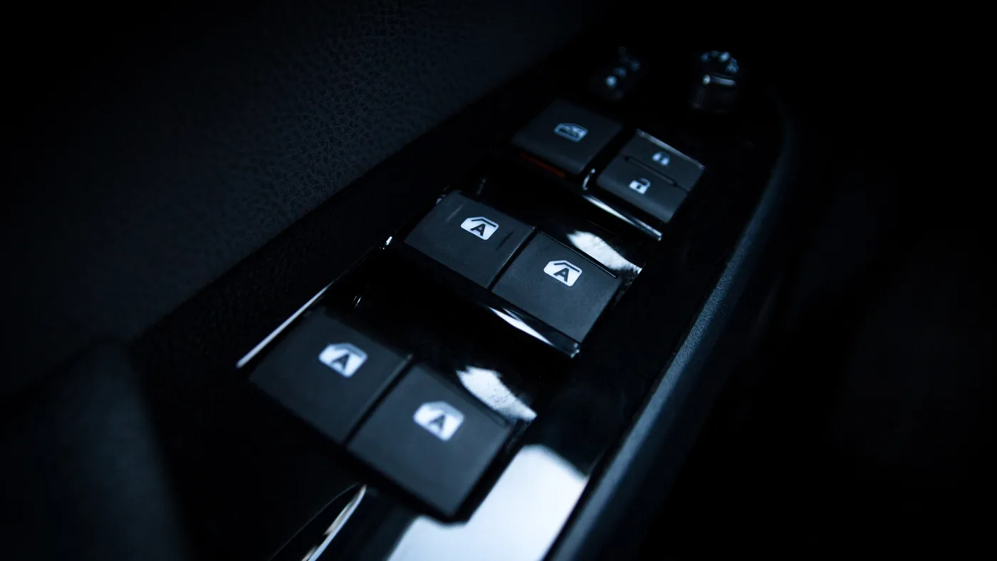 Driver’s door master switch panel with four one-touch auto window buttons, a window lock button and door lock buttons