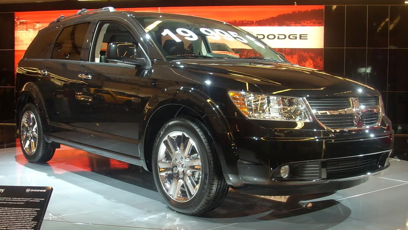 Black 2009 Dodge Journey SUV on display at an auto show, seen from the front right
