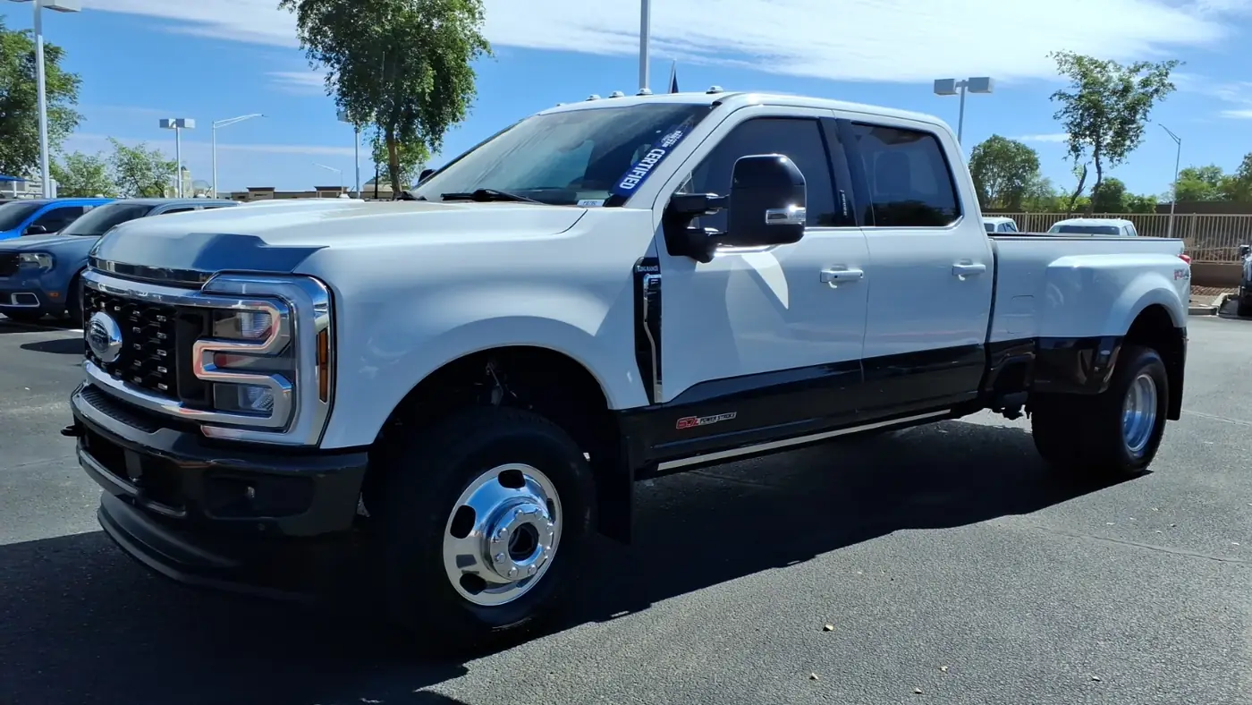 White Ford F-350 Super Duty King Ranch dual-rear-wheel crew cab pickup parked on a dealer lot